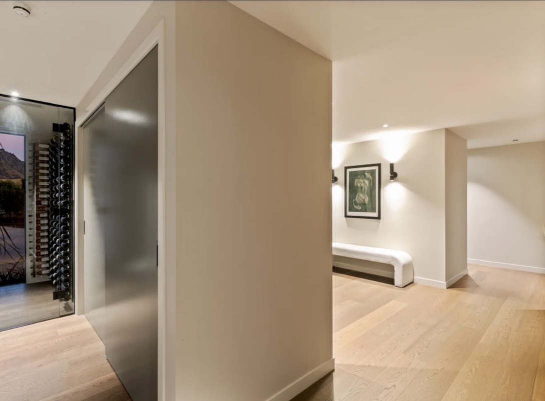 Contemporary hallway with soft neutral walls and oak flooring