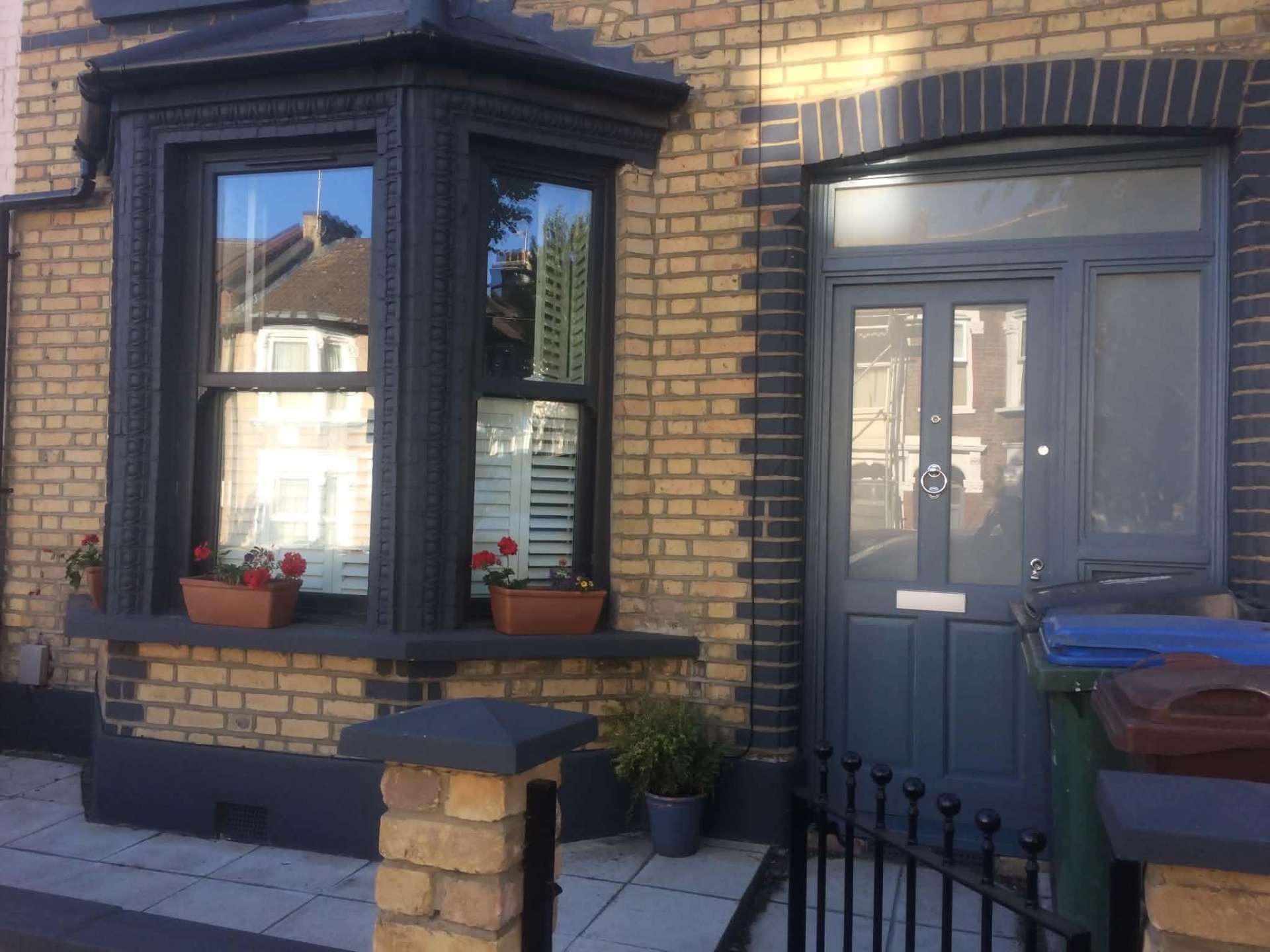 Victorian terrace exterior with charcoal masonry paint and repainted bay window
