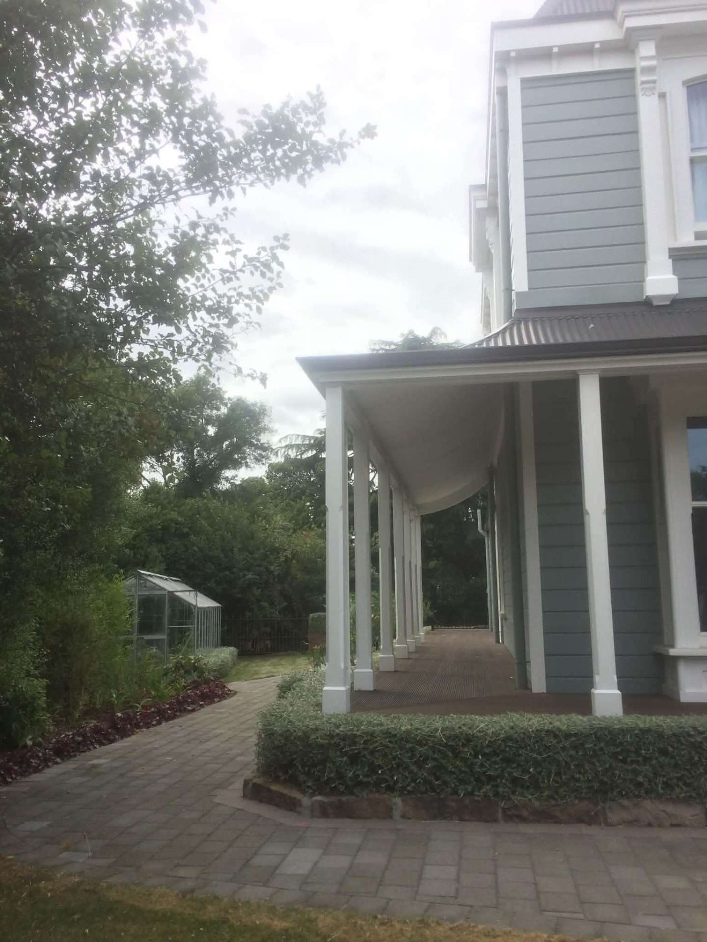Restored Victorian villa exterior in soft grey with white trims