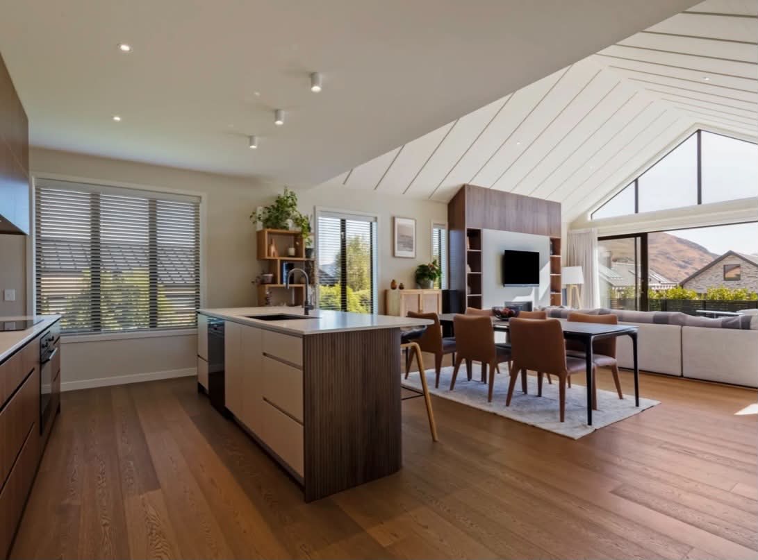 Open-plan kitchen and dining with warm white ceiling and walls